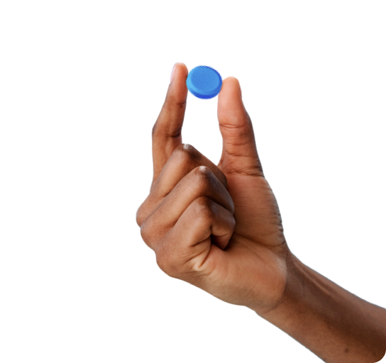 Fingers holding blue pill